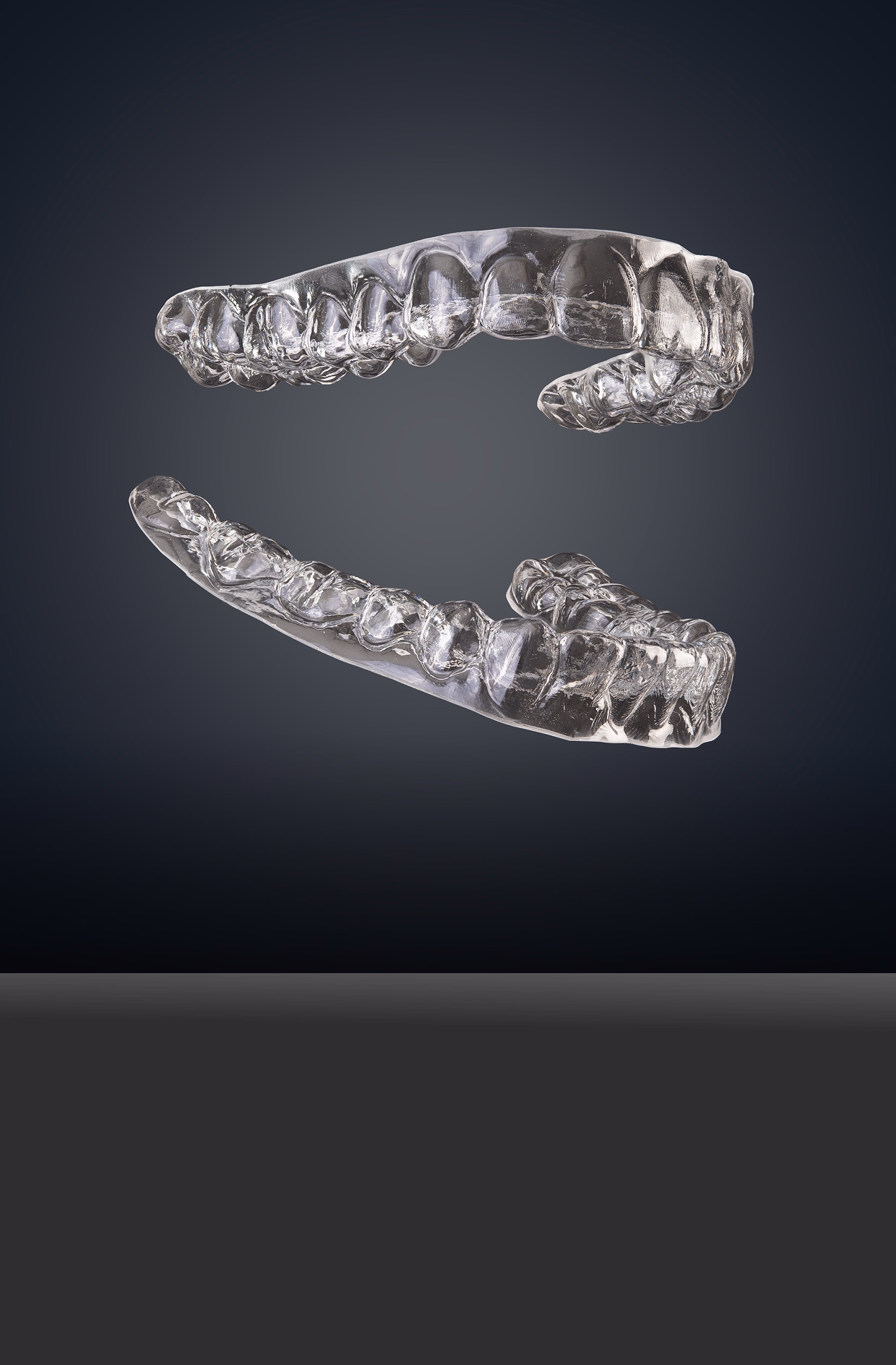 A person points to a 3D dental model on a touchscreen in a dental office, conveying a sense of modern technology and professional consultation.