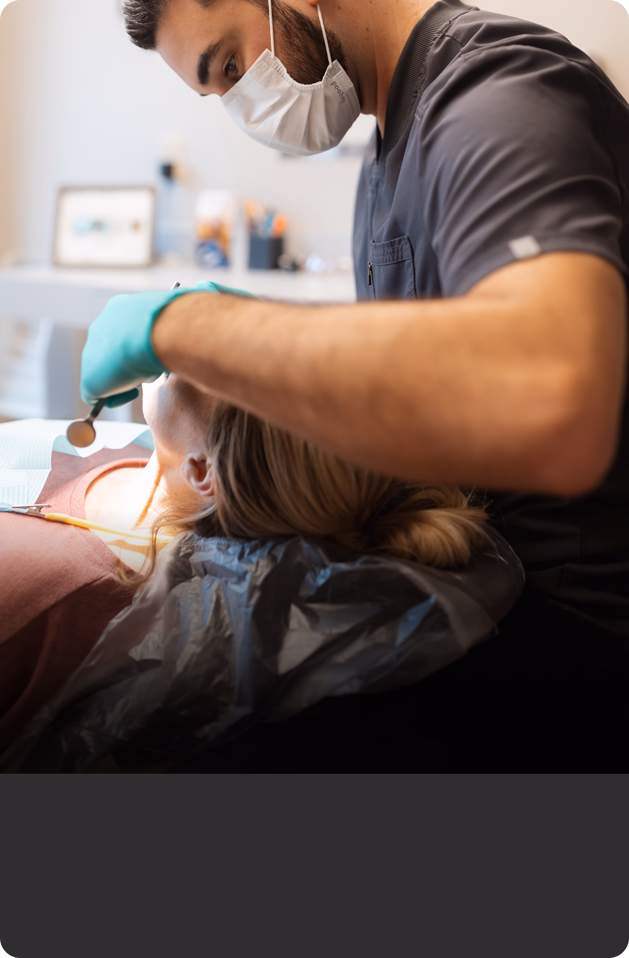 Dentist in a mask examines a patient's teeth with tools in a modern clinic. The patient lies on a chair, creating a calm and professional atmosphere.